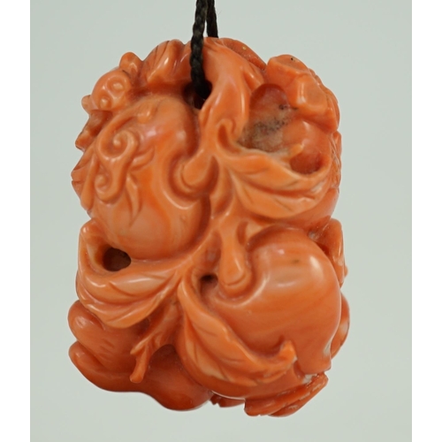 202 - A good Chinese coral fruit and bats pendant, 19th century, carved in high relief and open work wit... 