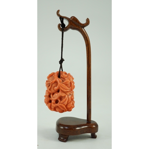 202 - A good Chinese coral fruit and bats pendant, 19th century, carved in high relief and open work wit... 