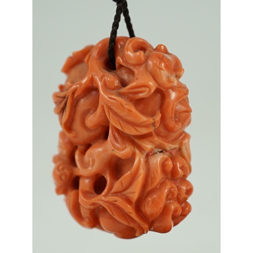 202 - A good Chinese coral fruit and bats pendant, 19th century, carved in high relief and open work wit... 