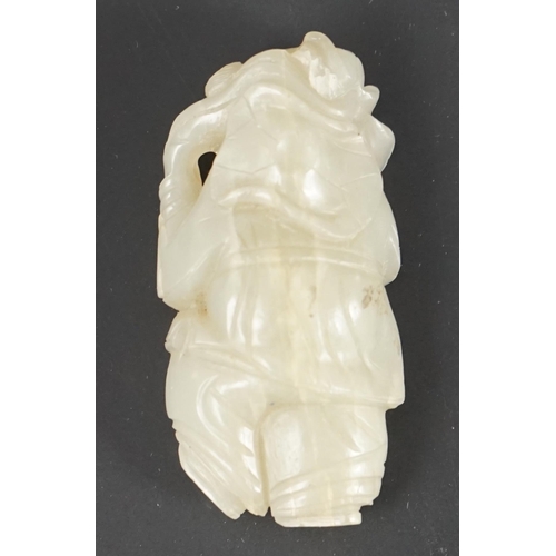 217 - A Chinese celadon jade figure of a boy holding a lotus sprig, 19th century 5.2 cm high