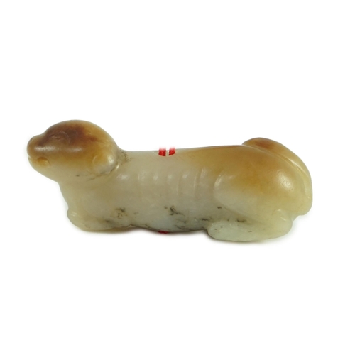 224 - A Chinese pale grey and russet jade figure of a hound, probably Song dynasty, the hound recumbent, p... 