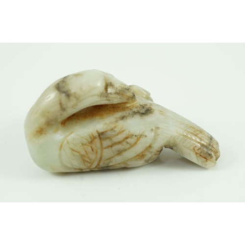 225 - A Chinese white and black jade figure of a preening duck, Ming dynasty, carved in relief with a spri... 