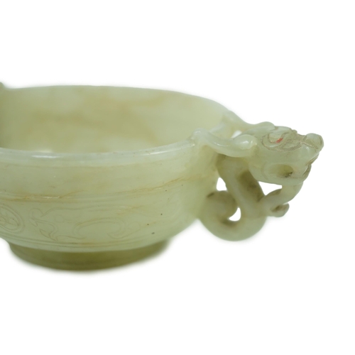 231 - A Chinese pale celadon jade two handled chilong cup, 17th/18th century, with a pair of carved drag... 