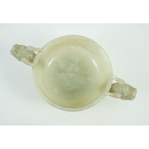 231 - A Chinese pale celadon jade two handled chilong cup, 17th/18th century, with a pair of carved drag... 