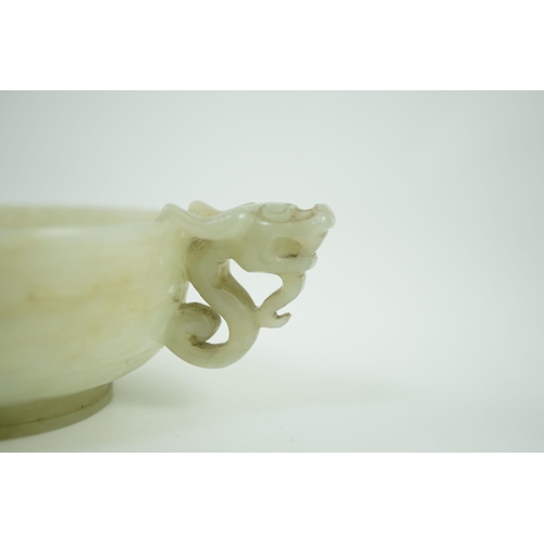 231 - A Chinese pale celadon jade two handled chilong cup, 17th/18th century, with a pair of carved drag... 