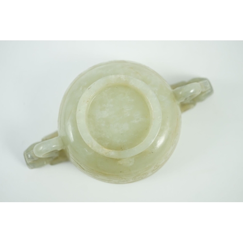 231 - A Chinese pale celadon jade two handled chilong cup, 17th/18th century, with a pair of carved drag... 