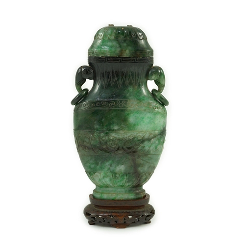 234 - A Chinese archaistic green jadeite vase and cover, late Qing dynasty, with a pair of elephant head r... 