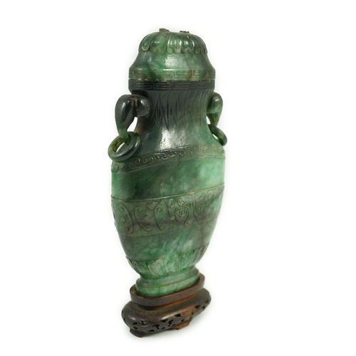 234 - A Chinese archaistic green jadeite vase and cover, late Qing dynasty, with a pair of elephant head r... 