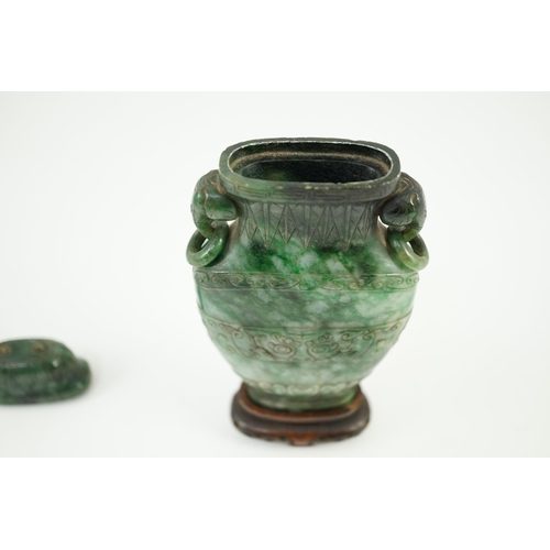 234 - A Chinese archaistic green jadeite vase and cover, late Qing dynasty, with a pair of elephant head r... 