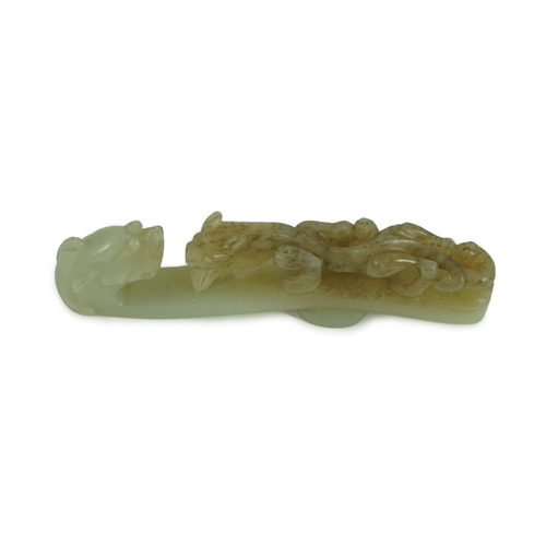 239 - A Chinese pale celadon and brown jade dragon belt hook, 18th/19th century 10.7 cm long