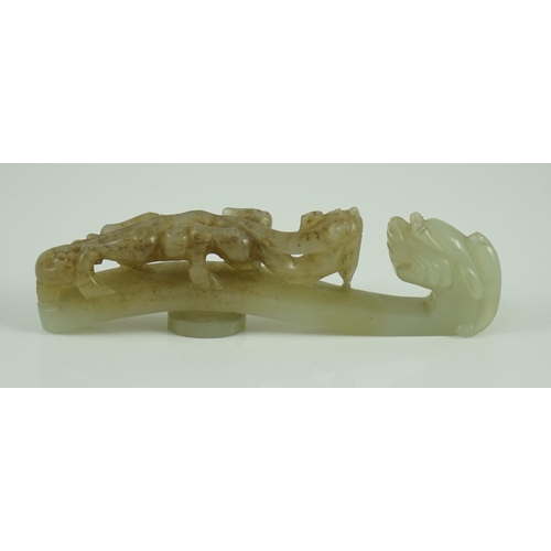 239 - A Chinese pale celadon and brown jade dragon belt hook, 18th/19th century 10.7 cm long