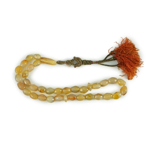 240 - A Sino-Tibetan row of agate prayer beads, 19th century Total drop including tassel 36 cm