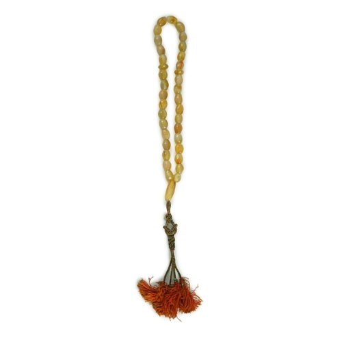 240 - A Sino-Tibetan row of agate prayer beads, 19th century Total drop including tassel 36 cm