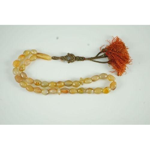 240 - A Sino-Tibetan row of agate prayer beads, 19th century Total drop including tassel 36 cm