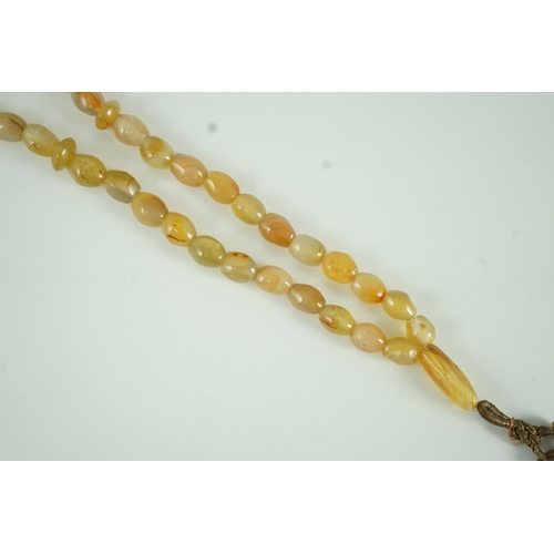 240 - A Sino-Tibetan row of agate prayer beads, 19th century Total drop including tassel 36 cm