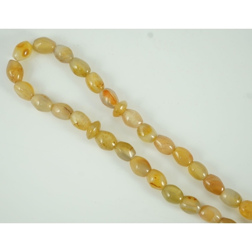 240 - A Sino-Tibetan row of agate prayer beads, 19th century Total drop including tassel 36 cm