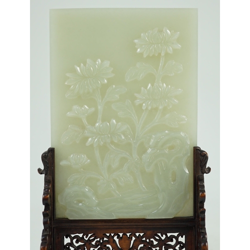 241 - A good Chinese celadon jade peonies and rockwork small table screen and stand, 18th/19th century, ... 