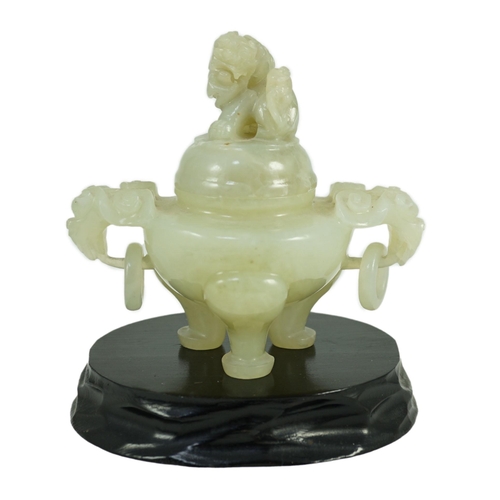 249 - A Chinese pale celadon jade tripod censer cover, 20th century, 12cm wide, wood stand