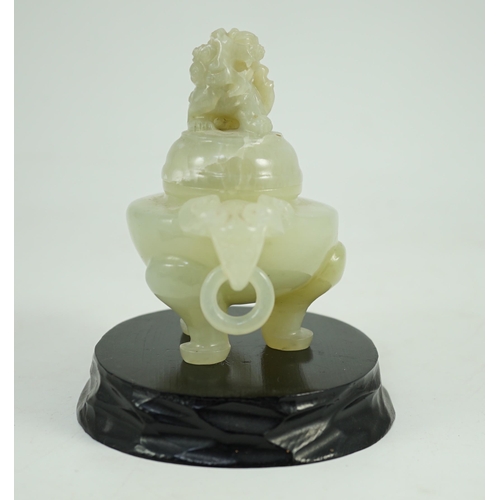 249 - A Chinese pale celadon jade tripod censer cover, 20th century, 12cm wide, wood stand