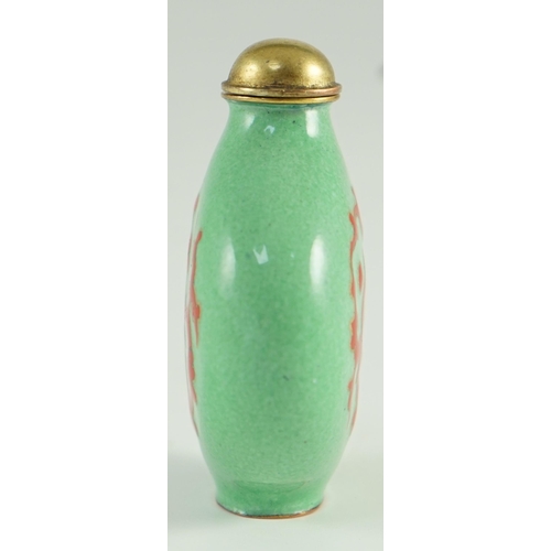 257 - A Chinese enamel on copper green ground snuff bottle, 19th/20th century, enamelled in red with a chi... 