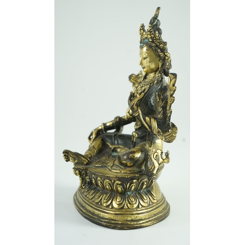 258 - A Sino-Tibetan bronze seated figure of Green Tara, 23.5 cm high