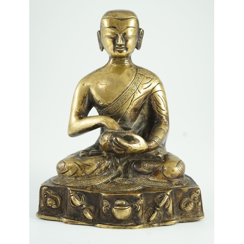 259 - A Himalayan bronze figure of Buddha, 19th century, the seated figure holding an alms bowl, the shape... 