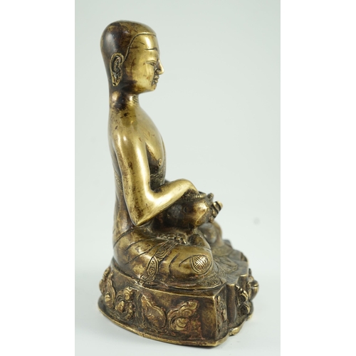 259 - A Himalayan bronze figure of Buddha, 19th century, the seated figure holding an alms bowl, the shape... 