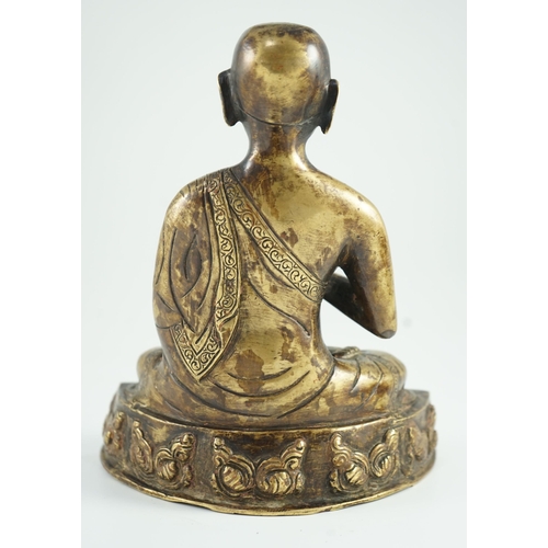 259 - A Himalayan bronze figure of Buddha, 19th century, the seated figure holding an alms bowl, the shape... 