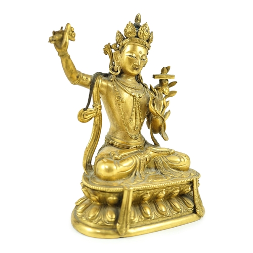 260 - A Tibetan gilt bronze seated figure of Vajrasattva, finely cast and gilded, 16.5 cm high