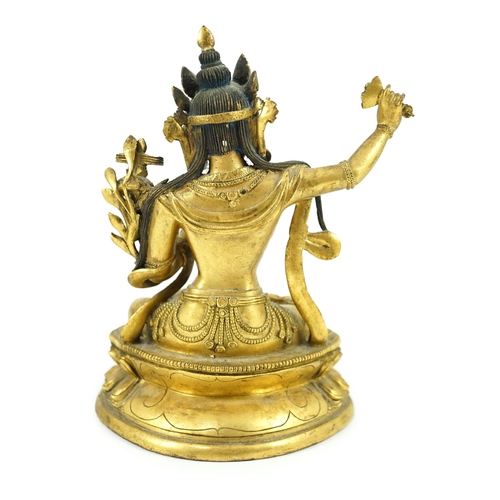 260 - A Tibetan gilt bronze seated figure of Vajrasattva, finely cast and gilded, 16.5 cm high