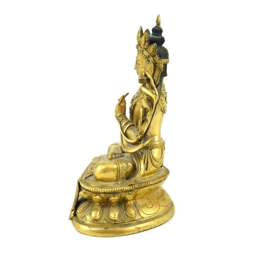 260 - A Tibetan gilt bronze seated figure of Vajrasattva, finely cast and gilded, 16.5 cm high