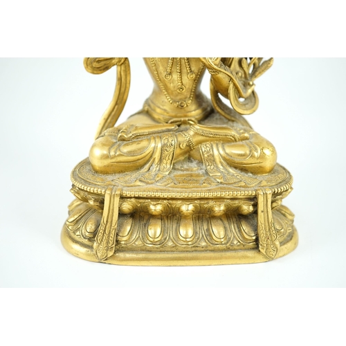 260 - A Tibetan gilt bronze seated figure of Vajrasattva, finely cast and gilded, 16.5 cm high