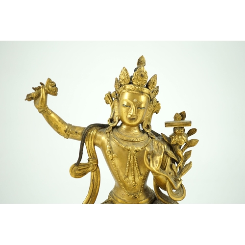 260 - A Tibetan gilt bronze seated figure of Vajrasattva, finely cast and gilded, 16.5 cm high