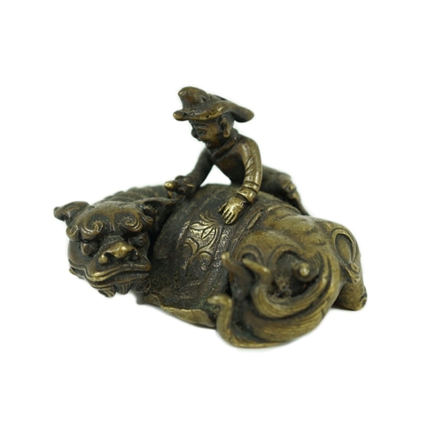 262 - A Chinese bronze Buddhist lion scroll weight, 17th/18th century, cast as a recumbent caparisoned l... 