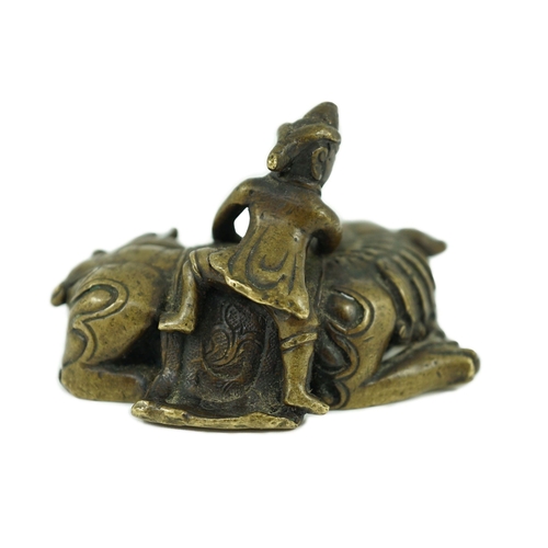 262 - A Chinese bronze Buddhist lion scroll weight, 17th/18th century, cast as a recumbent caparisoned l... 