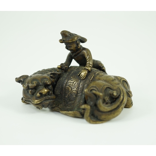 262 - A Chinese bronze Buddhist lion scroll weight, 17th/18th century, cast as a recumbent caparisoned l... 