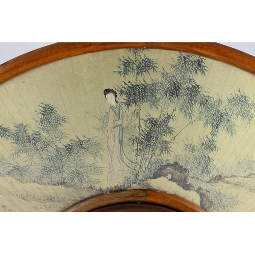 272 - A Chinese painted and inscribed gilt paper fan leaf, 19th century, painted with a lady standing in a... 