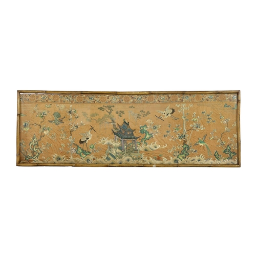 273 - A Chinese apricot ground embroidered silk table frontal, late Qing dynasty, finely worked with a cen... 