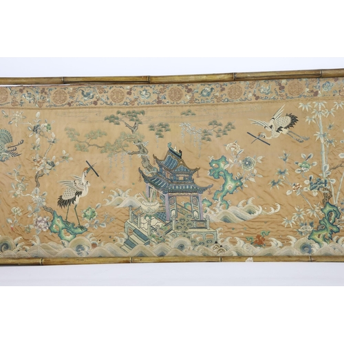 273 - A Chinese apricot ground embroidered silk table frontal, late Qing dynasty, finely worked with a cen... 