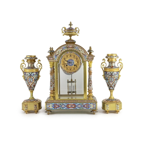 282 - An early 20th century French ormolu and champleve enamel clock garniture, the mantel clock of archit... 