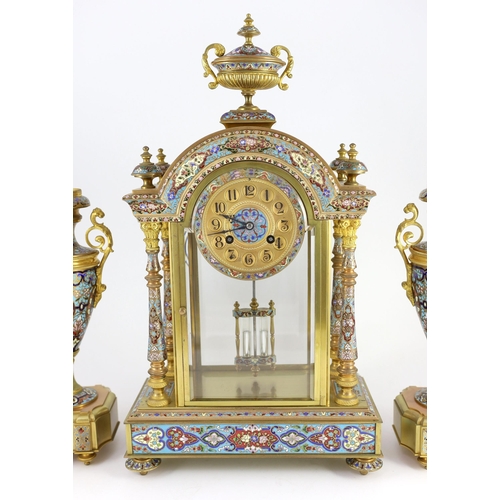 282 - An early 20th century French ormolu and champleve enamel clock garniture, the mantel clock of archit... 