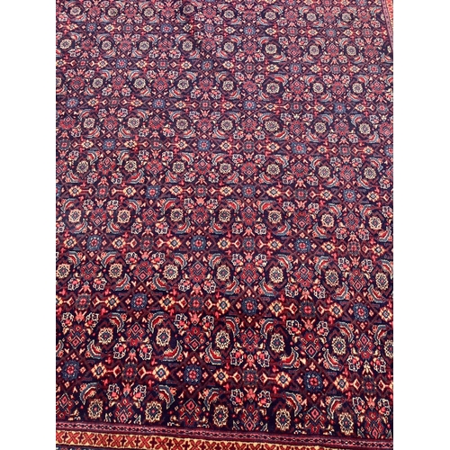 293 - A North West Persian blue ground carpet, with central field of stylised floral motifs, multi-bordere... 