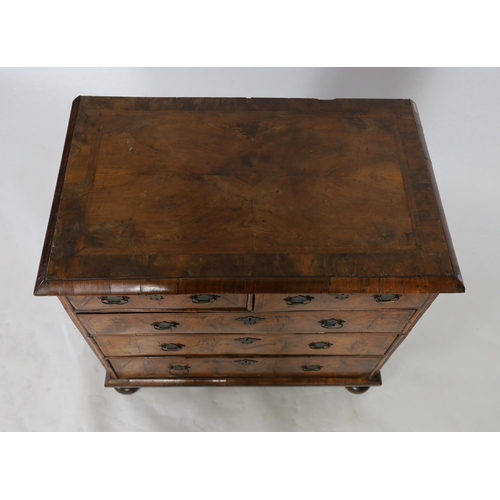 298 - A George I figured walnut chest of two short and three graduated long drawers, on turned feet, W.96c... 