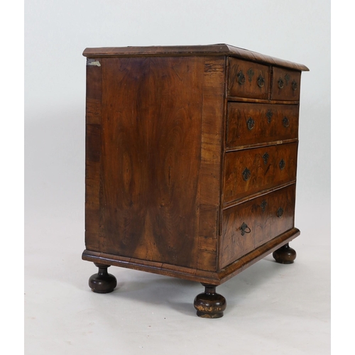 298 - A George I figured walnut chest of two short and three graduated long drawers, on turned feet, W.96c... 