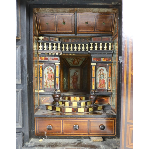 300 - An early 18th century Portuguese ebonised table cabinet, of architectural form, with central door en... 