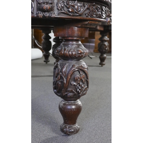 301 - A late Victorian carved oak extending dining table, with rounded D shaped ends and four leaves, the ... 