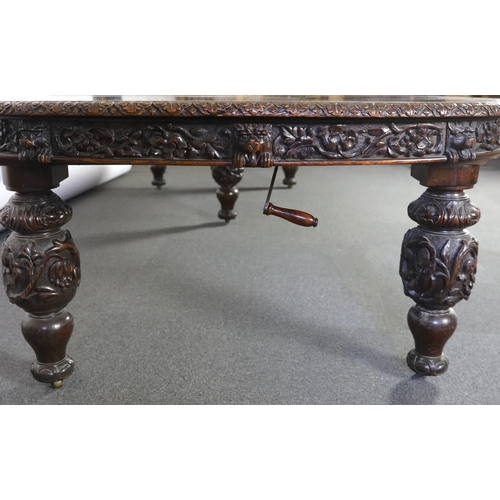 301 - A late Victorian carved oak extending dining table, with rounded D shaped ends and four leaves, the ... 