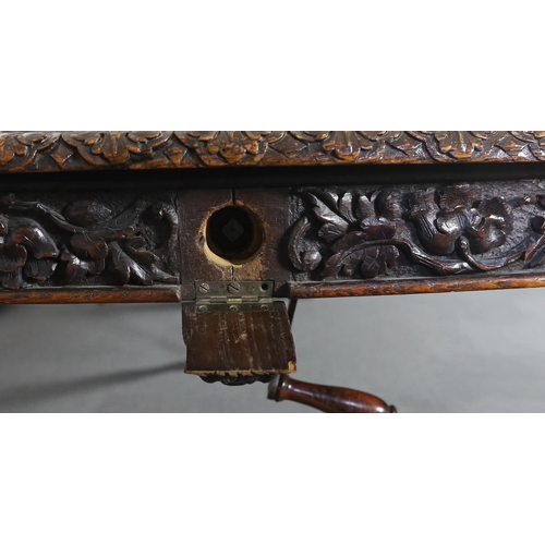 301 - A late Victorian carved oak extending dining table, with rounded D shaped ends and four leaves, the ... 