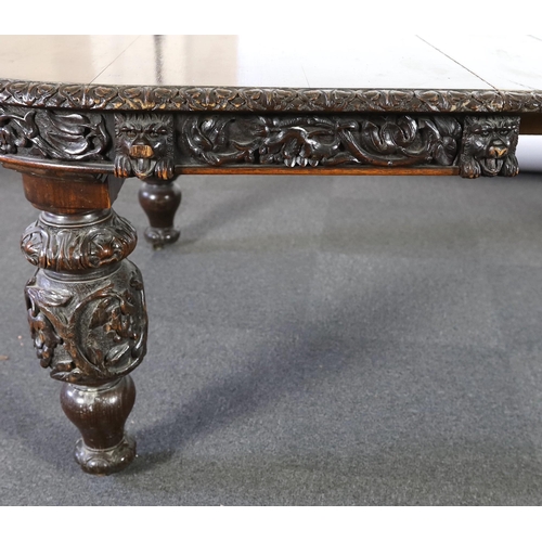 301 - A late Victorian carved oak extending dining table, with rounded D shaped ends and four leaves, the ... 