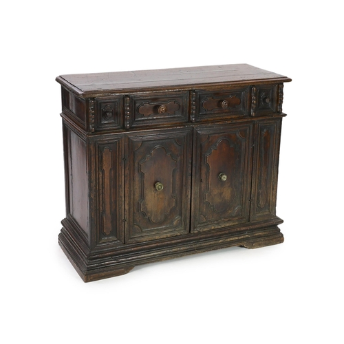 303 - A 17th century Tuscan walnut credenza, the rectangular moulded top, over a pair of shaped oval field... 